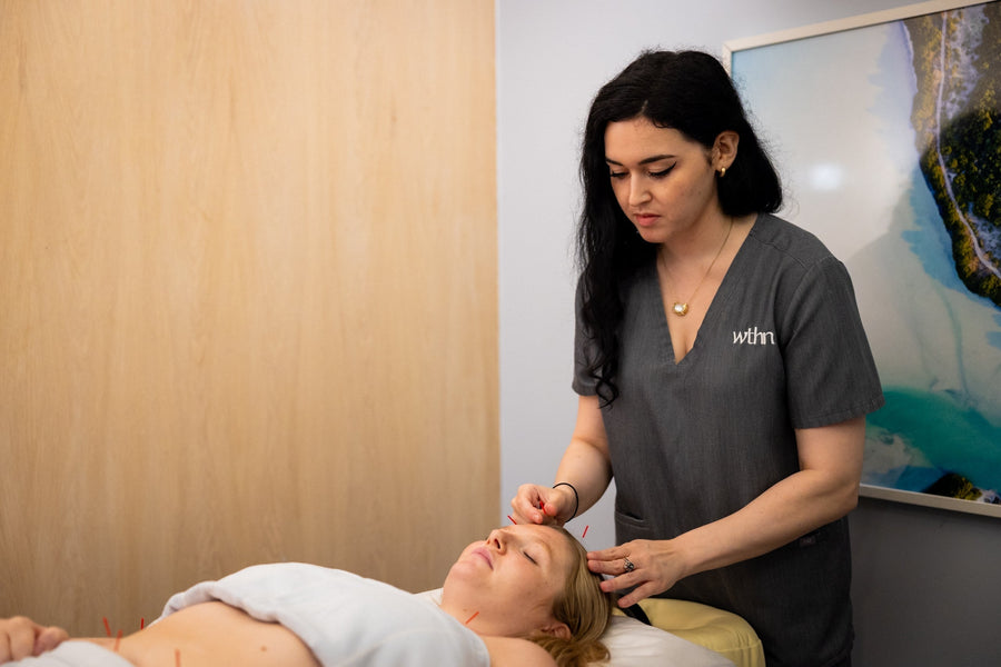 acupuncturist working on patient
