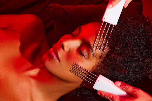 Woman receiving microcurrent therapy on her face.