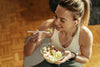 Smiling woman eating a salad