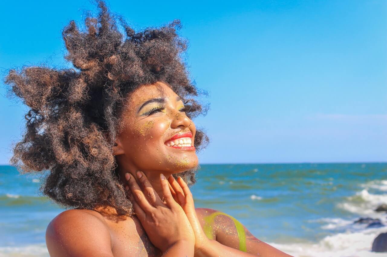 A woman on the beach smiling
