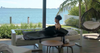 Woman relaxing in a HigherDOSE Infrared Sauna Blanket in a spa near the beach