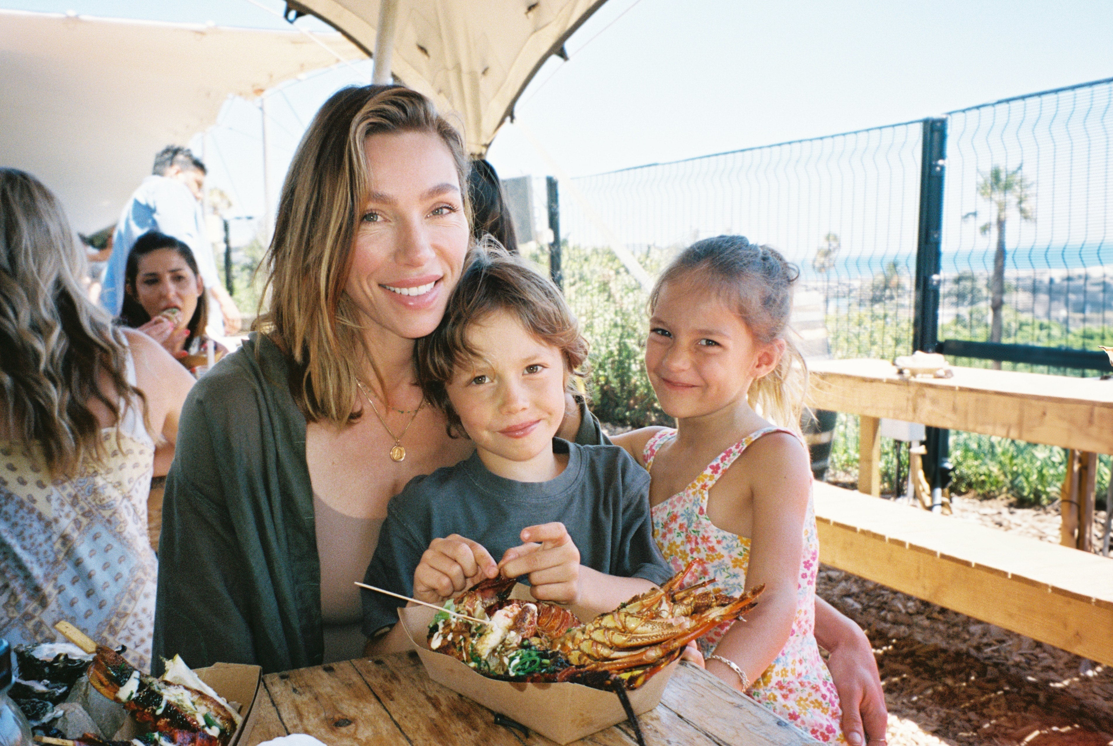 Image of Lauren Berlingeri and her two children smiling