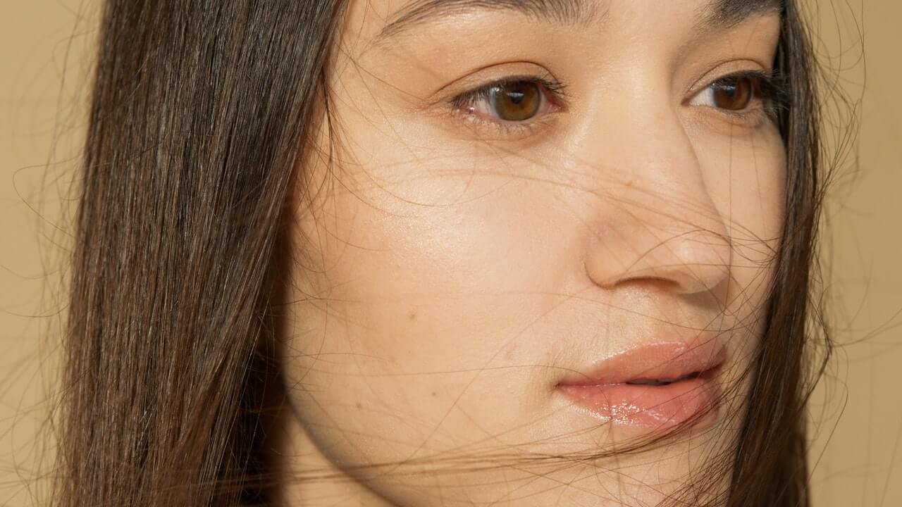 Woman with clear skin looking to her side