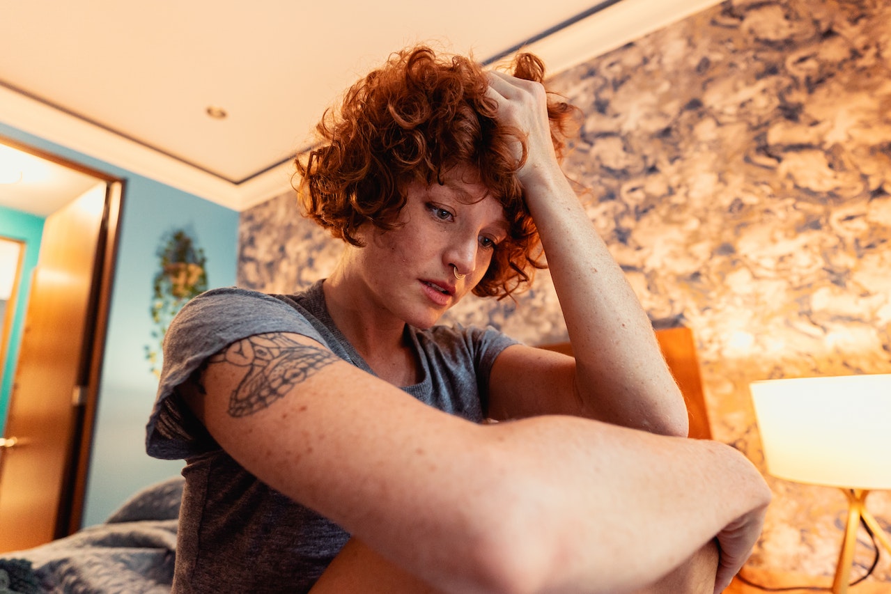 Stressed woman with short, curly hair