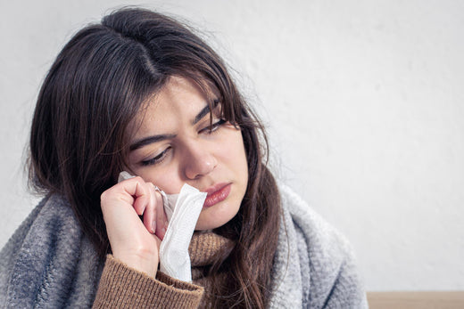 A sick, young woman wearing a sweater