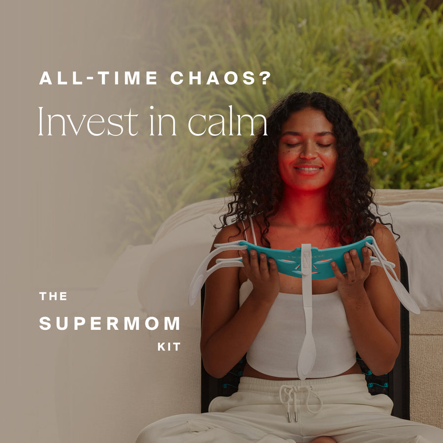 Woman sitting on couch holding turquoise and white fabric relaxation product with eyes closed.