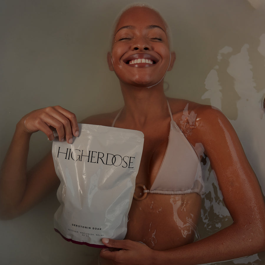 Person holding a white pouch labeled 