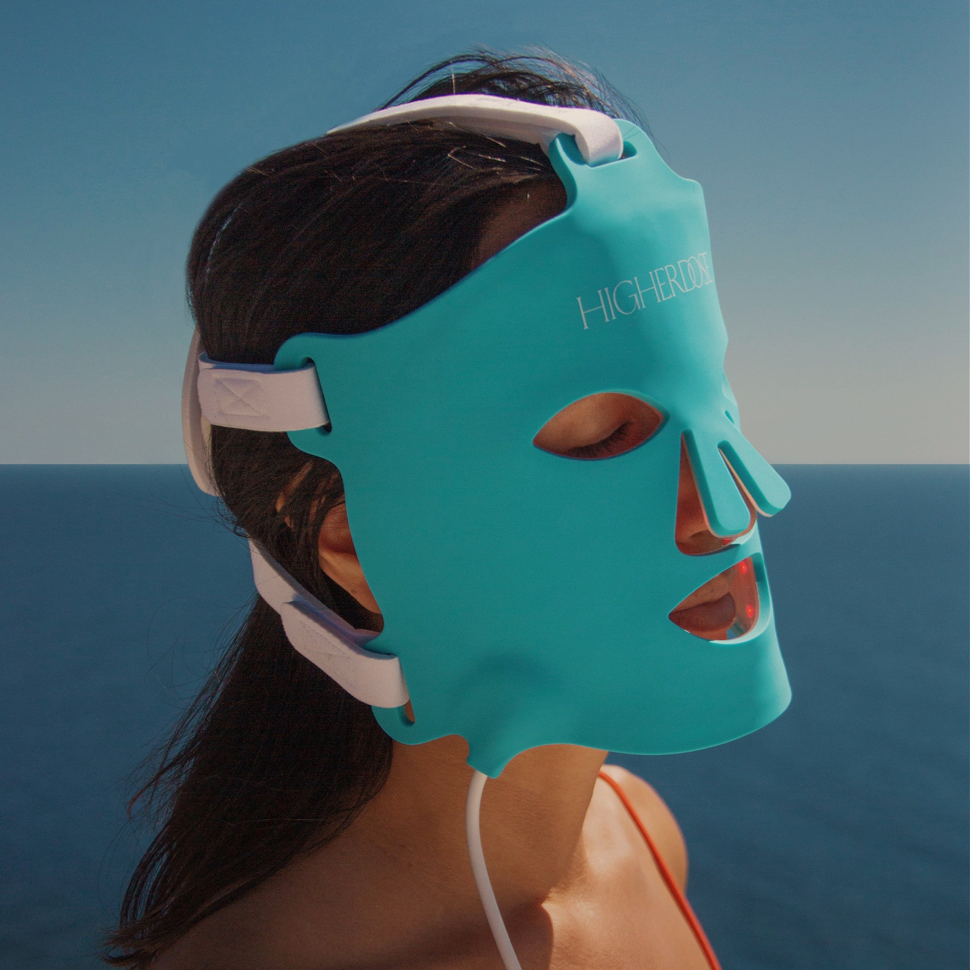 HigherDose Red Light Mask being worn, highlighting its flexible silicone design
