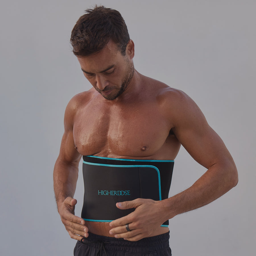 Man wearing black abdominal wrap with teal trim and 