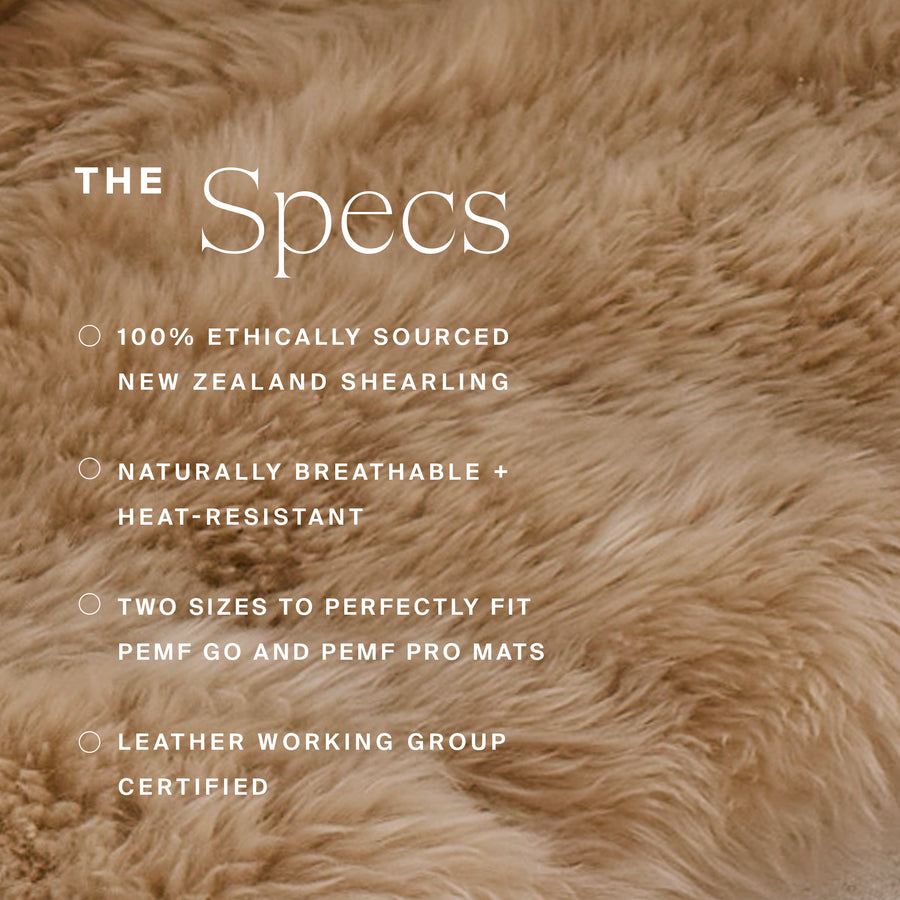 Tan and cream woolly sheep shearling fabric with natural texture and soft fibers throughout.