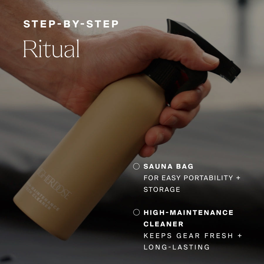 Hand holding tan cylindrical sauna bag with black cap and cleaning bottle.