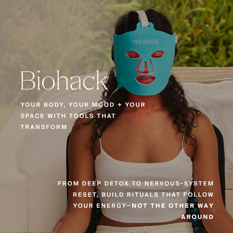 Person wearing turquoise face mask with red facial features and white headband strap.