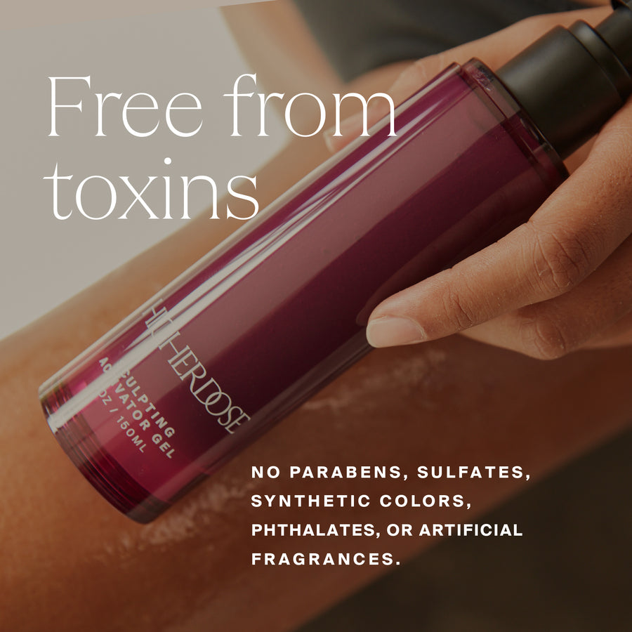 Burgundy gel bottle with black cap held in hand against neutral background.