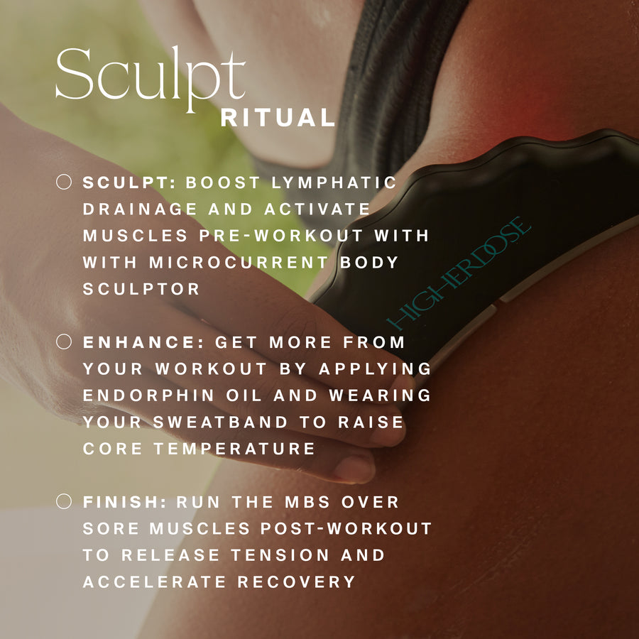 Black microcurrent body sculpting device being held against an arm during use.