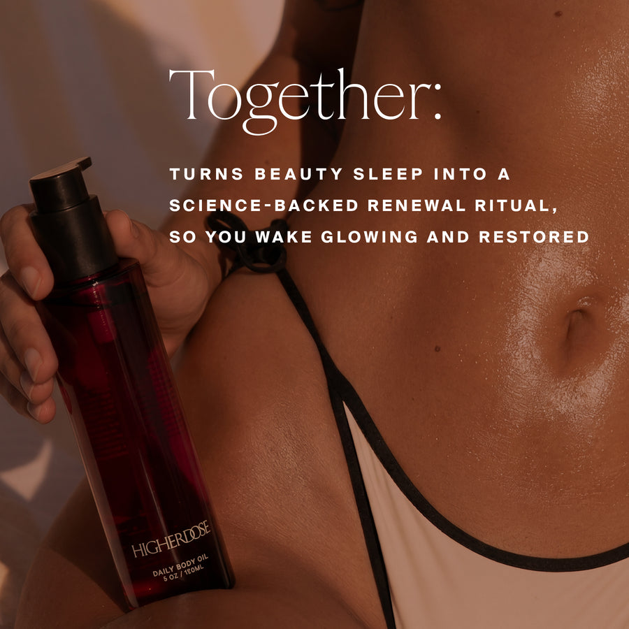 Dark red body oil bottle held in hand beside glowing skin with shoulder strap visible.