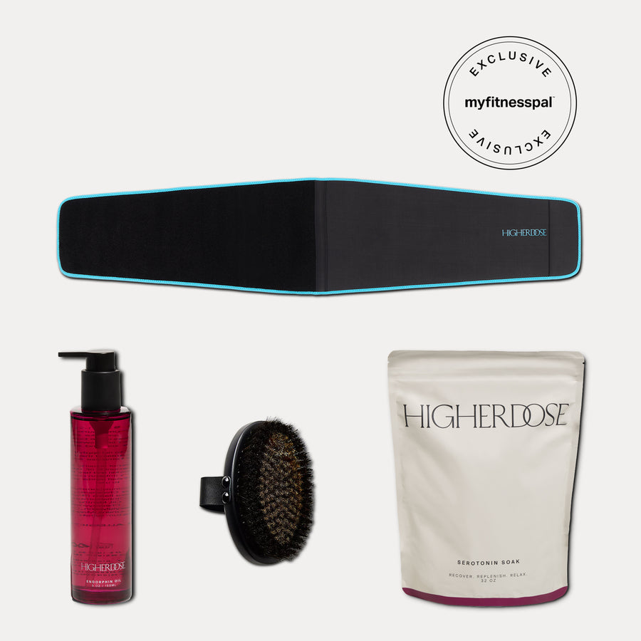 Black waist belt with blue trim, pink liquid product with pump dispenser, black body brush, and white pouch labeled Higherdos