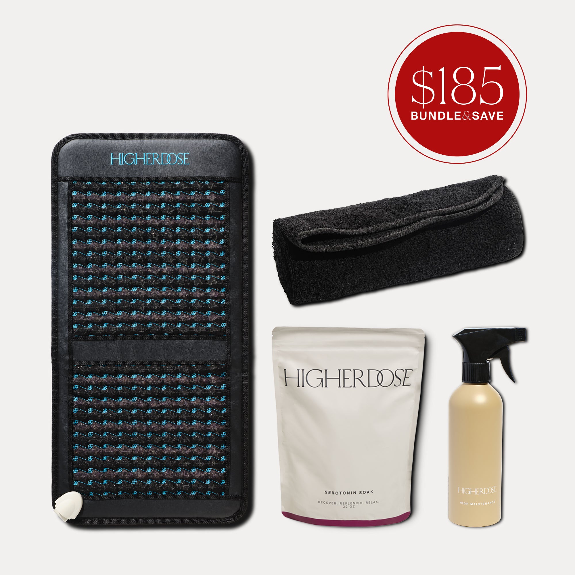 Black PEMF mat with blue light pattern, black headwrap, white serotonin soak pouch, and tan spray bottle.