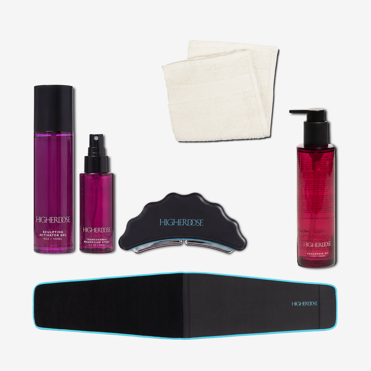 Five-piece skincare kit including two purple bottles, one red bottle, black facial tool, white towels, and blue-trimmed black