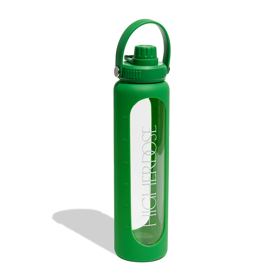 Green glass water bottle with time markers, green screw-top cap, and carrying handle.