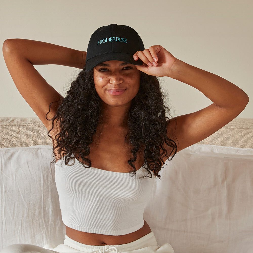 Woman wearing the HigherDOSE Red Light Hat for red light therapy to support hair growth and scalp health.