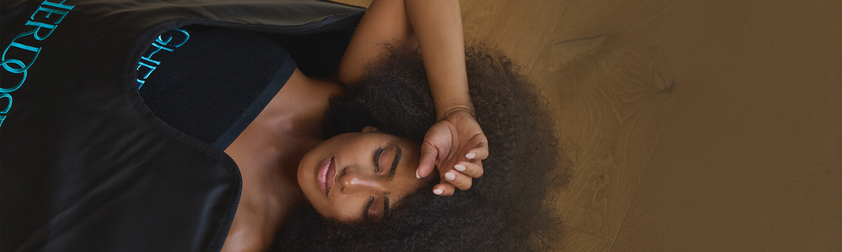 Woman lying on a brown surface with a blurred background
