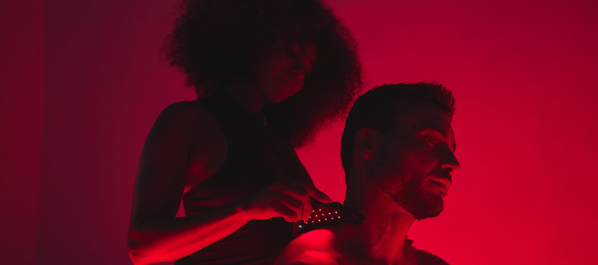 Person using the HigherDOSE Microcurrent Body Sculptor with red and near-infrared light to boost circulation and skin energy.