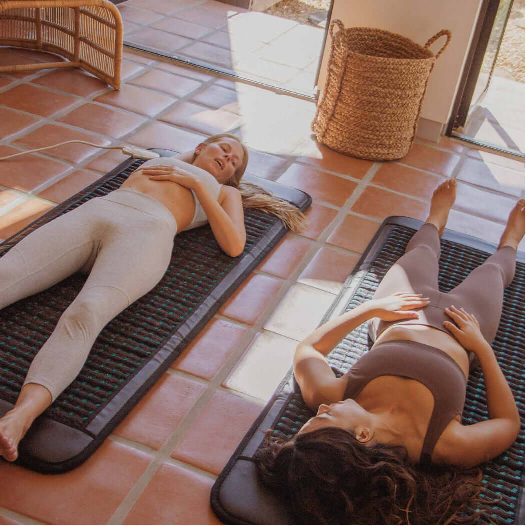 two women lying down on higherdose pemf mats
