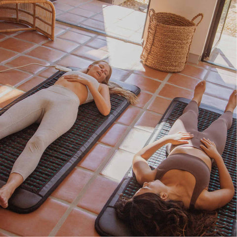 two women lying down on higherdose pemf mats