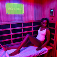 A woman in a HigherDOSE infrared sauna box