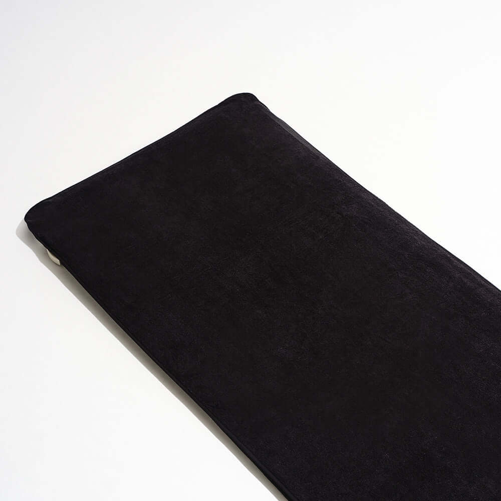 A black fabric HigherDOSE PEMF Mat Cover